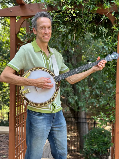 Josh Turknett playing banjo outdoors