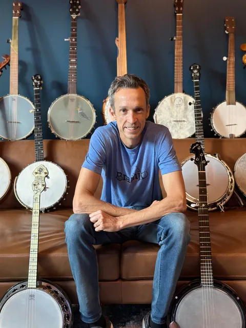Josh Turknett with a wall of banjos